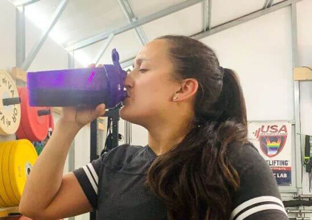woman drinking pre workout